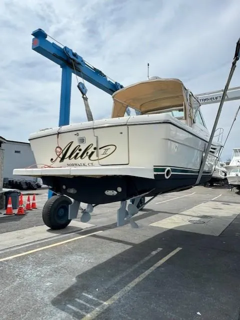 Slide: The Image of 2001 Pursuit 3000 Express boat on lift, Norwalk, CT, marina setting. - 4