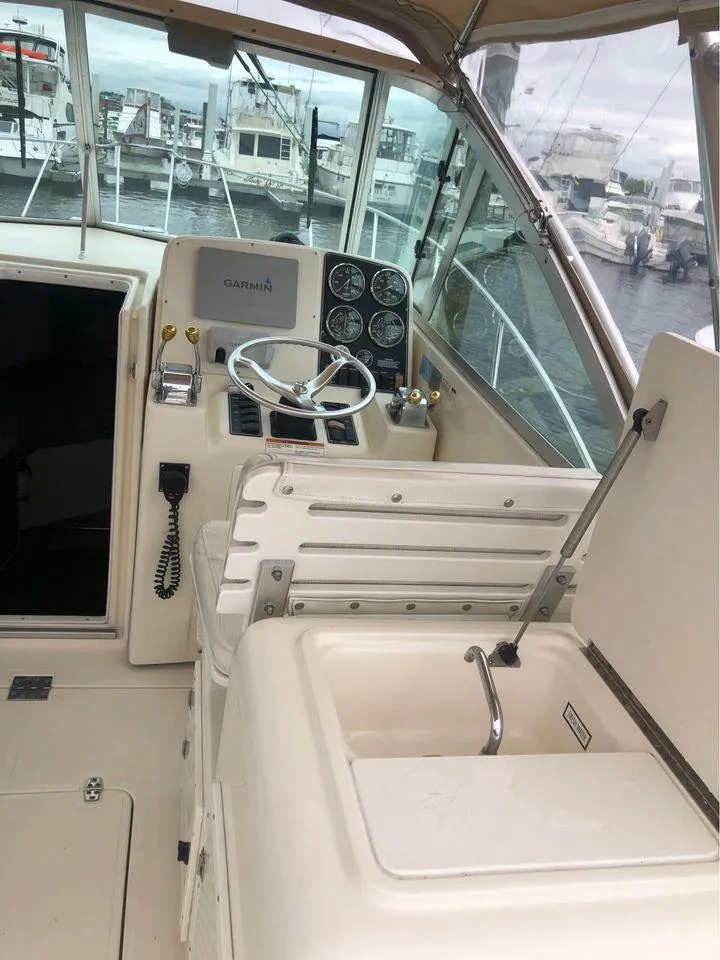 Slide: The Image of 2001 Pursuit 3000 Express boat helm with steering wheel and control panel. - 6