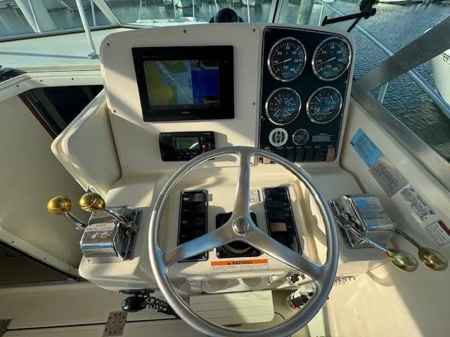 Slide: The Image of Helm of 2001 Pursuit 3000 Express boat with navigation equipment and controls. - 7