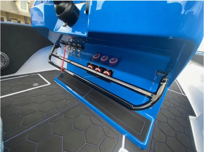 Slide: The Image of 2021 Statement 380 Open boat dashboard with blue panel and control switches. - 11