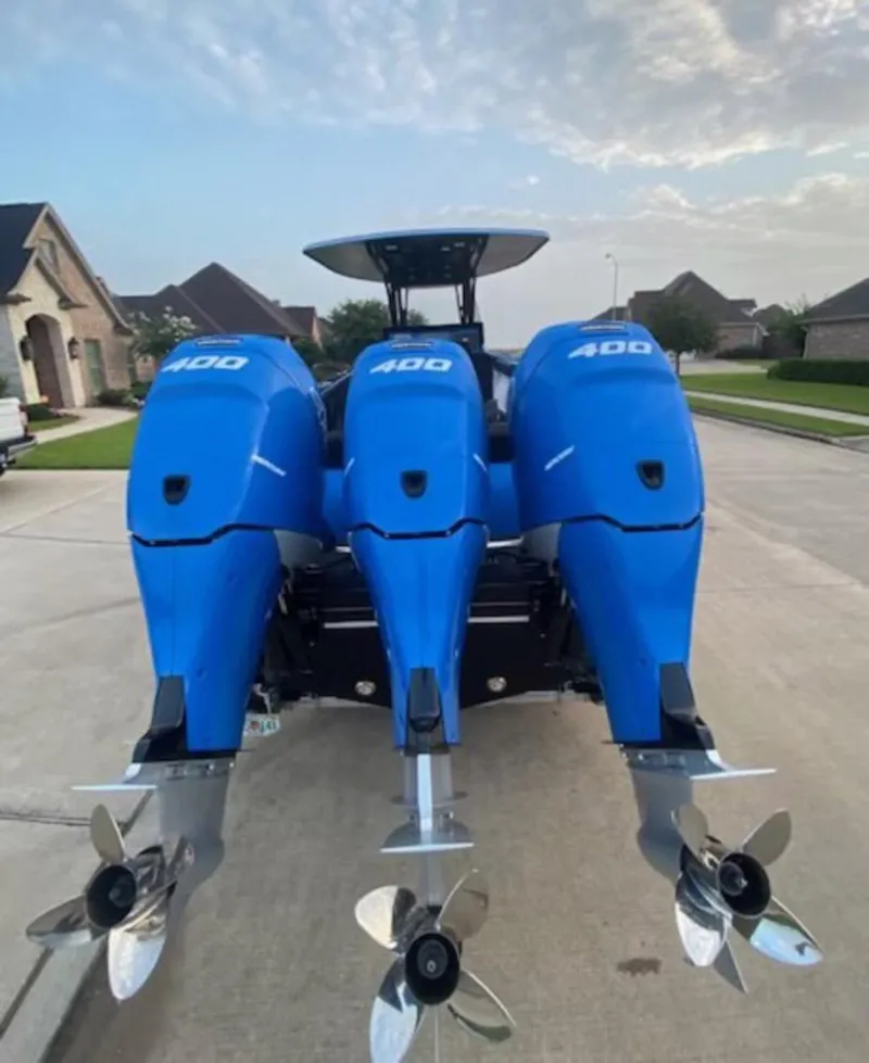 Slide: The Image of 2021 Statement 380 Open boat with triple 400 horsepower engines, parked in a residential area. - 18