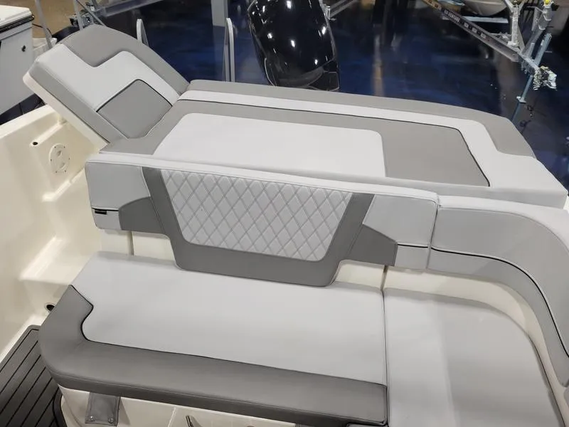 Slide: The Image of 2025 Bayliner VR5 OB boat interior with gray and white cushioned seating. - 11