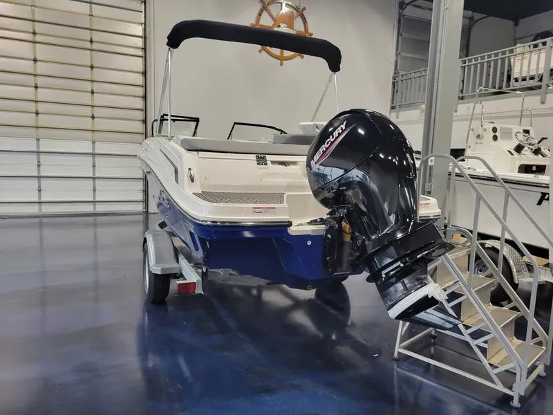 Slide: The Image of 2025 Bayliner VR5 OB boat with Mercury outboard motor in showroom. - 3