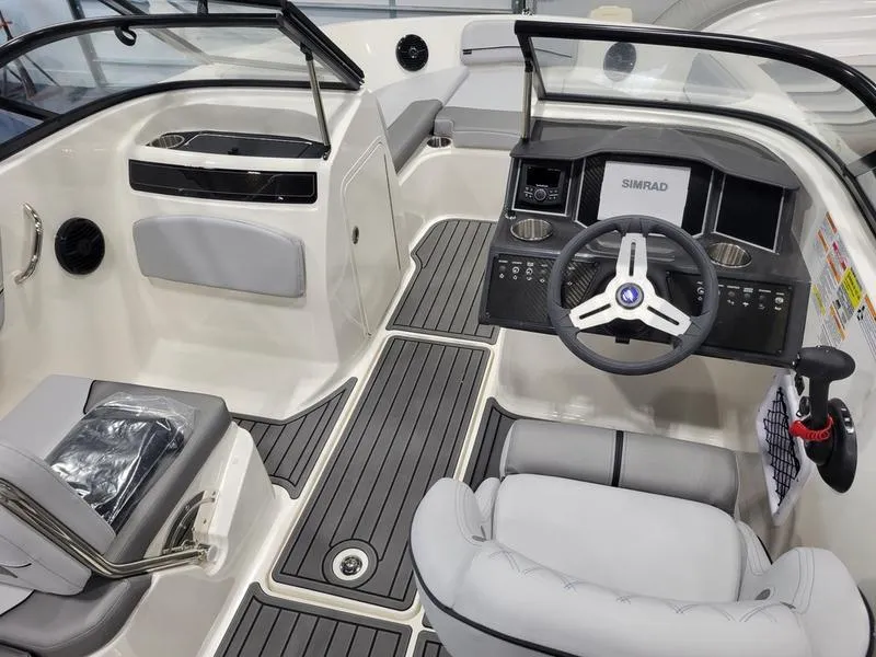 Slide: The Image of 2025 Bayliner VR5 OB boat interior with modern dashboard and seating. - 7