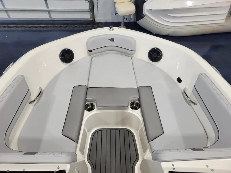 Slide: The Image of 2025 Bayliner VR5 OB boat interior with gray seating and cup holders. - 8