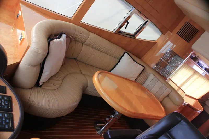 Slide: The Image of Luxurious interior of 2004 Horizon P70 yacht with plush seating and wooden table. - 11