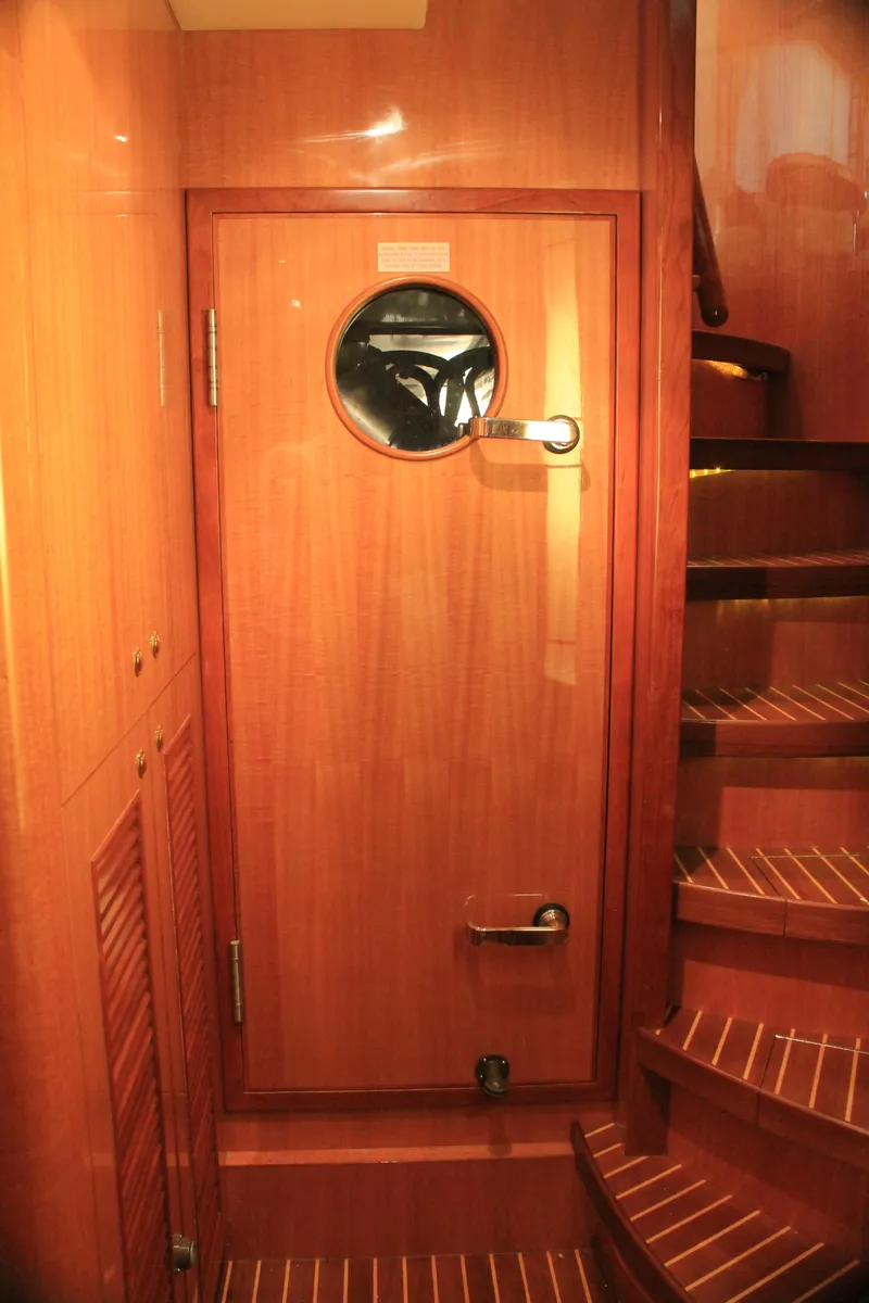 Slide: The Image of Wooden interior of 2004 Horizon P70 yacht with porthole door and spiral staircase. - 14
