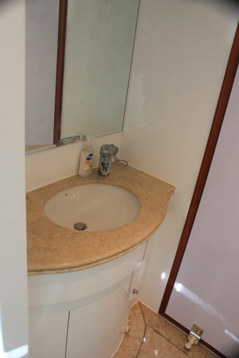 Slide: The Image of 2004 Horizon P70 yacht bathroom with beige countertop and mirror. - 29