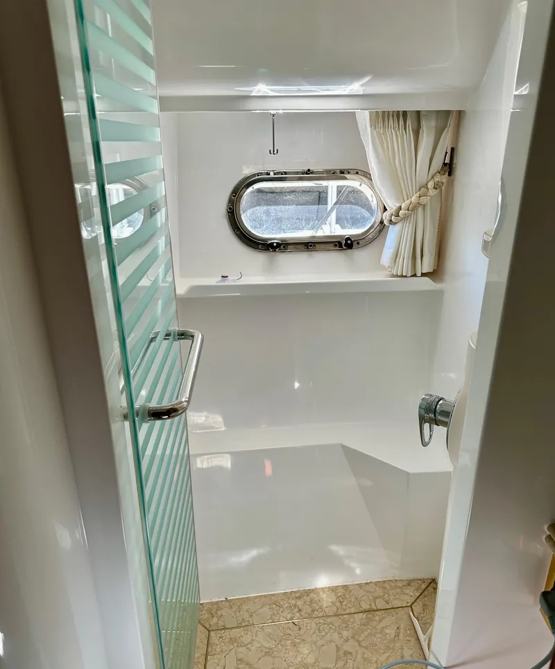 Slide: The Image of Luxurious bathroom in 2004 Horizon P70 yacht with glass door and porthole window. - 30