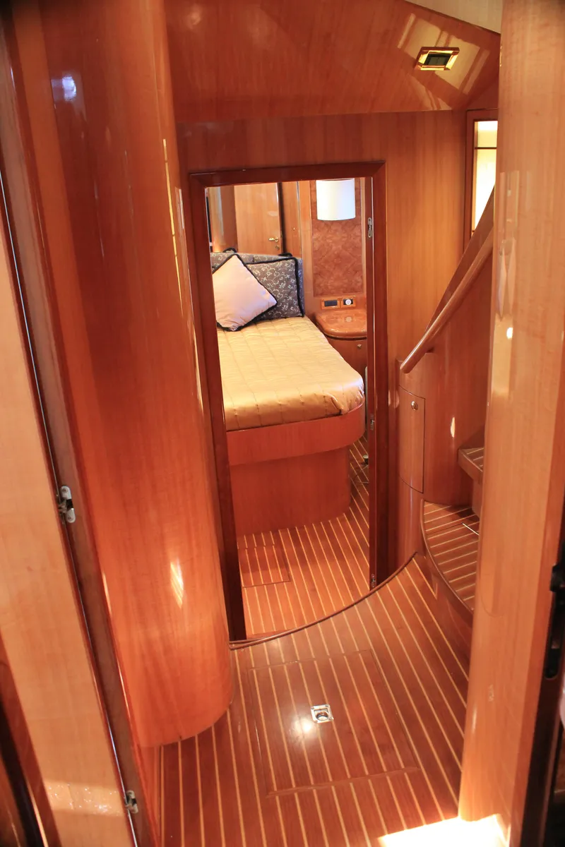 Slide: The Image of Luxurious wooden interior of 2004 Horizon P70 yacht cabin with bed and stairs. - 31