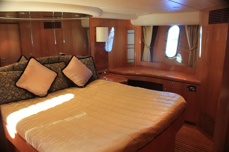 Slide: The Image of Luxurious cabin interior of 2004 Horizon P70 yacht with elegant bedding and wood finishes. - 35