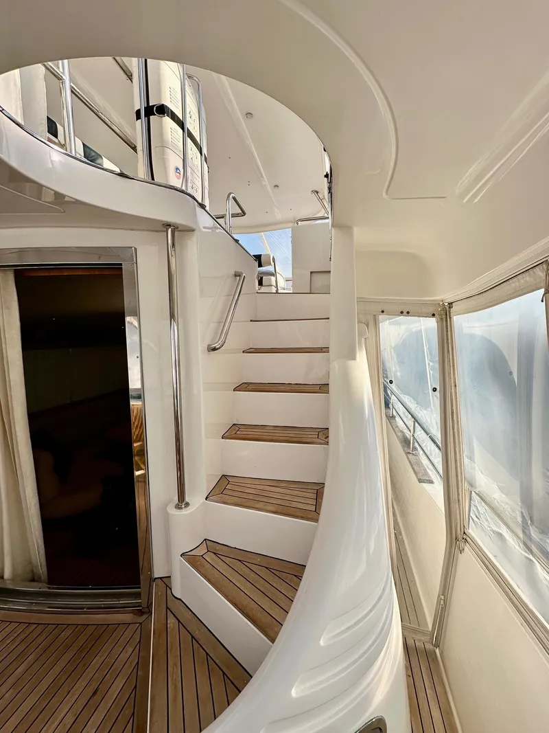 Slide: The Image of Elegant interior staircase of 2004 Horizon P70 yacht with wooden steps and modern design. - 4