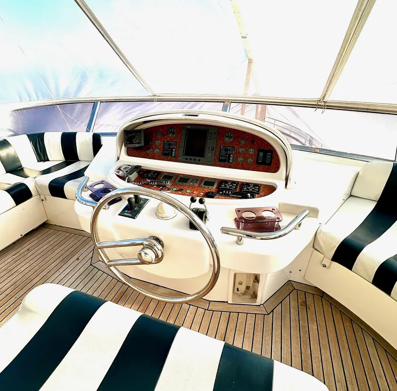 Slide: The Image of Helm of 2004 Horizon P70 yacht with striped seating and wooden deck. - 41