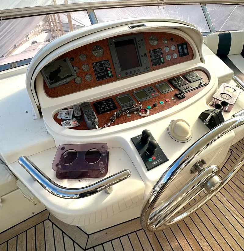 Slide: The Image of 2004 Horizon P70 yacht helm with navigation controls and steering wheel. - 42