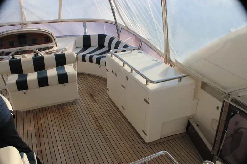 Slide: The Image of Luxurious 2004 Horizon P70 yacht interior with striped seating and wooden flooring. - 44
