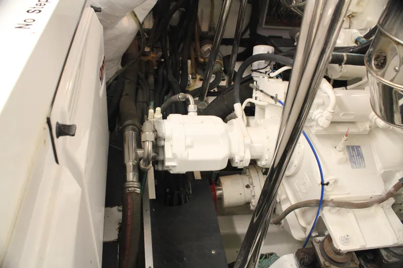 Slide: The Image of Engine room of 2004 Horizon P70 yacht, showcasing mechanical components and wiring. - 49
