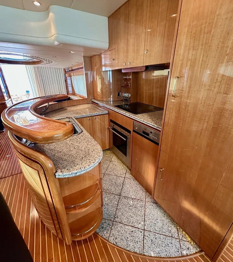 Slide: The Image of Luxurious kitchen interior of 2004 Horizon P70 yacht with wood and granite finishes. - 8