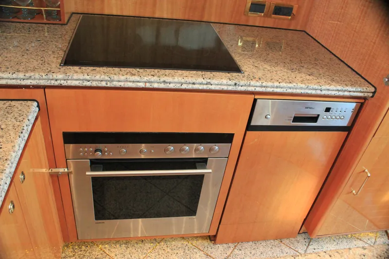 Slide: The Image of Modern kitchen with granite countertops, built-in oven, and stovetop on Horizon P70 yacht. - 9