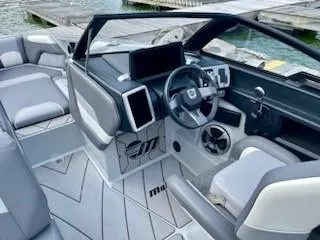 Slide: The Image of 2021 Malibu Wakesetter 25 LSV interior with modern dashboard and seating. - 4