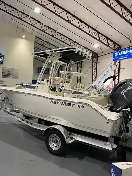 The Image of 2025 Key West 203 FS boat displayed indoors on a trailer. - 1