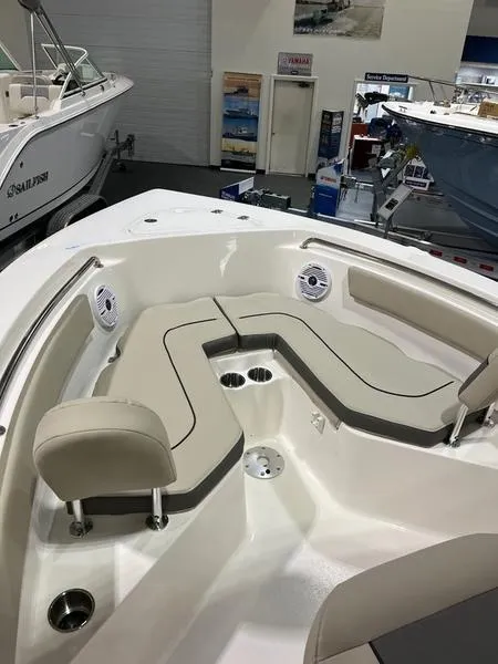 Slide: The Image of 2025 Key West 203 FS boat interior with cushioned seating and cup holders. - 10