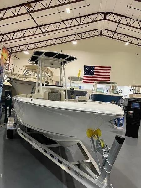 Slide: The Image of 2025 Key West 203 FS boat in showroom with American flag backdrop. - 3