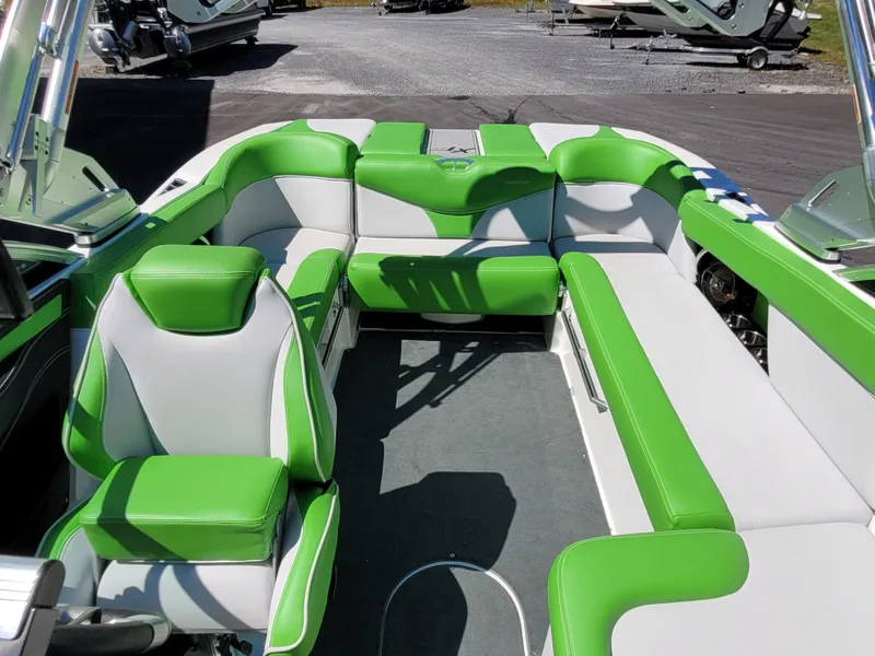 Slide: The Image of 2019 MasterCraft XT23 boat interior with green and white seating. - 12