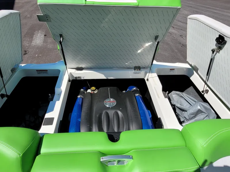 Slide: The Image of 2019 MasterCraft XT23 boat engine compartment with vibrant green seating. - 14
