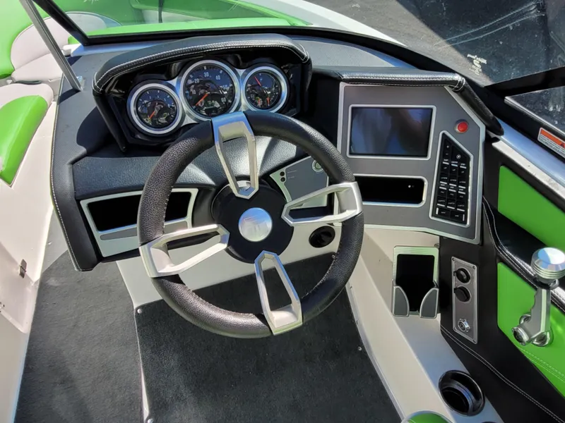 Slide: The Image of 2019 MasterCraft XT23 boat dashboard with steering wheel and control panel. - 9