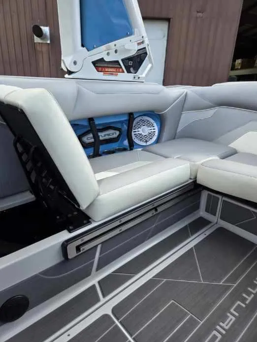 Slide: The Image of 2023 Centurion Ri230 boat interior with white seating and speaker system. - 10