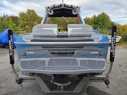 Slide: The Image of 2023 Centurion Ri230 boat rear view with seating and swim platform. - 3