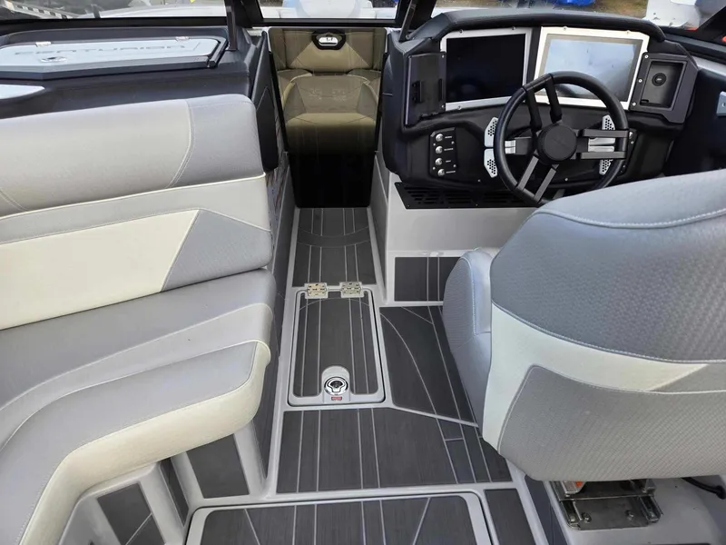 Slide: The Image of 2023 Centurion Ri230 boat interior with modern dashboard and seating. - 7