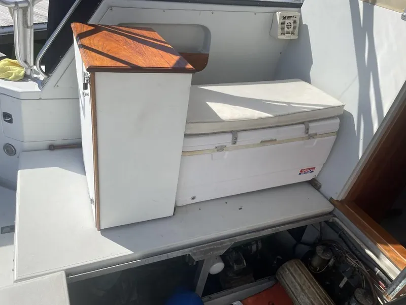 Slide: The Image of 1987 Rampage 31 Express boat interior with seating and storage area. - 11