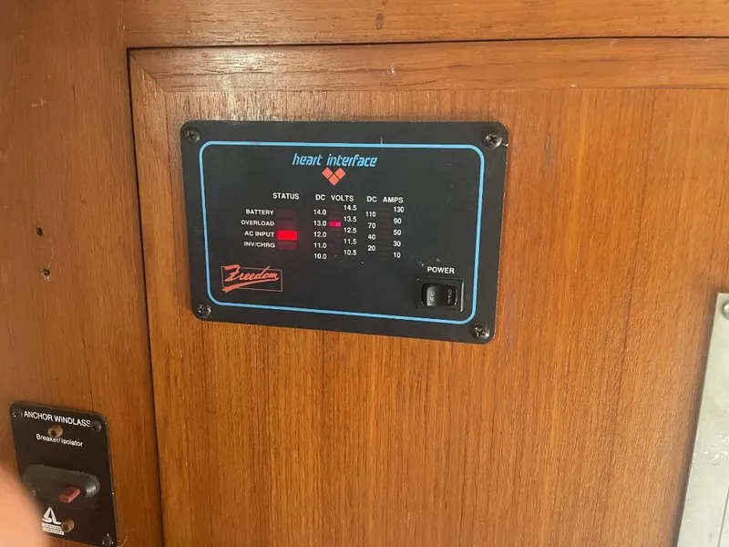 Slide: The Image of Control panel on 1987 Rampage 31 Express boat, displaying voltage and amperage readings. - 13
