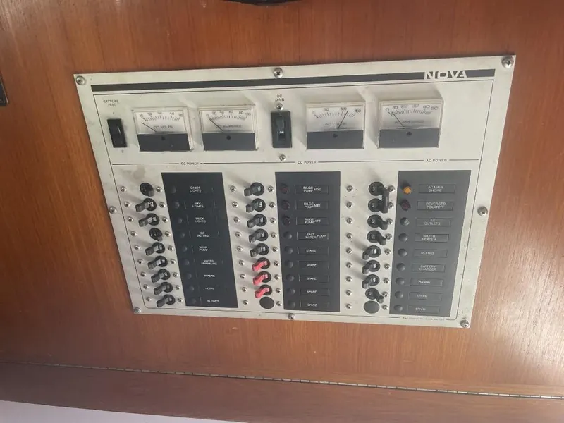 Slide: The Image of Electrical panel on a 1987 Rampage 31 Express boat, featuring switches and gauges. - 14