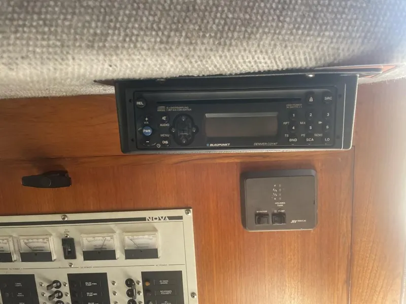 Slide: The Image of 1987 Rampage 31 Express boat interior with control panel and stereo system. - 15