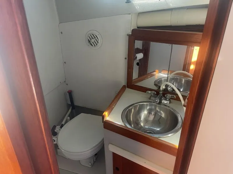 Slide: The Image of 1987 Rampage 31 Express boat bathroom with sink and toilet. - 16