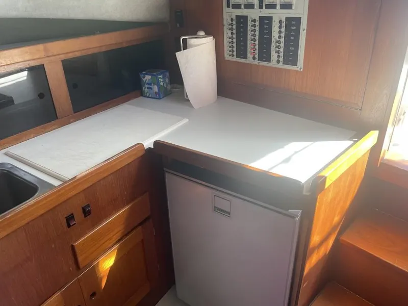 Slide: The Image of 1987 Rampage 31 Express boat interior with kitchenette and control panel. - 19
