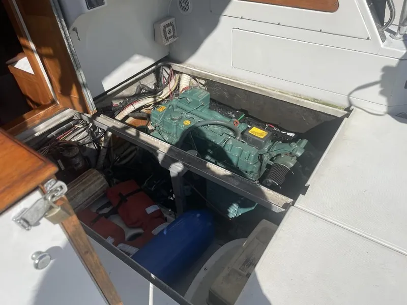 Slide: The Image of 1987 Rampage 31 Express engine compartment with visible equipment and storage items. - 9