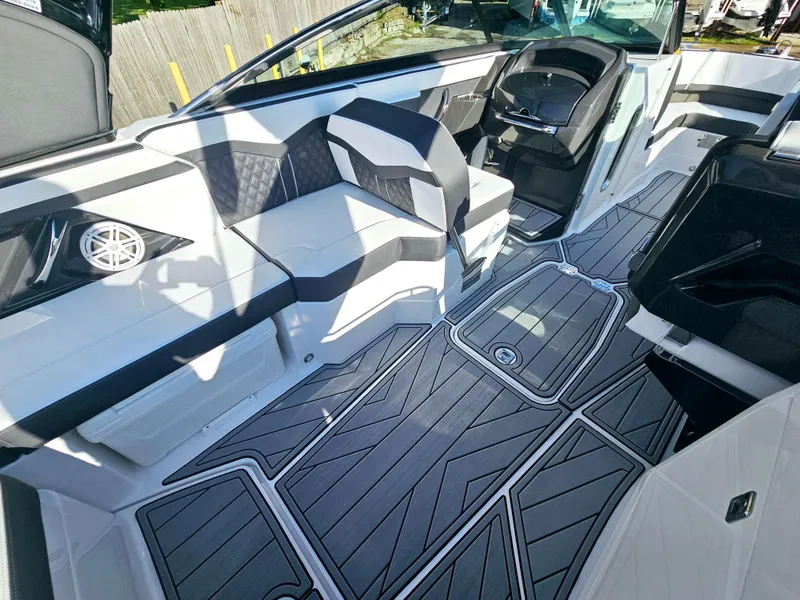Slide: The Image of 2025 Monterey 255SS boat interior with sleek seating and modern design. - 15