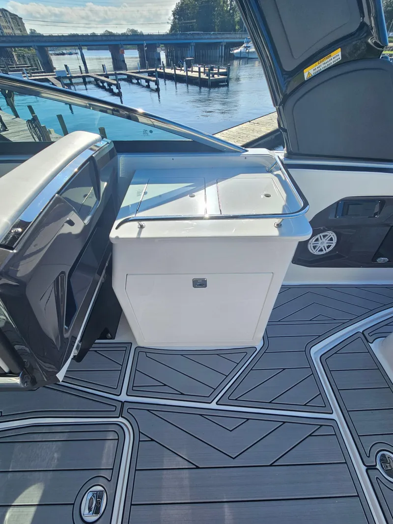Slide: The Image of 2025 Monterey 255SS boat interior with sleek design and waterfront view. - 16