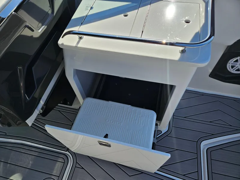 Slide: The Image of Open storage compartment on 2025 Monterey 255SS boat with sleek flooring. - 19
