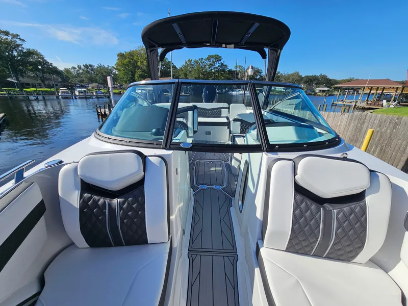 Slide: The Image of 2025 Monterey 255SS boat interior with luxurious seating and sleek design on a sunny day. - 27
