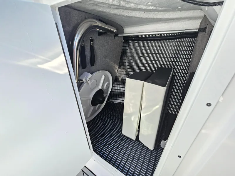Slide: The Image of Storage compartment in 2025 Monterey 255SS boat with organized equipment and accessories. - 29