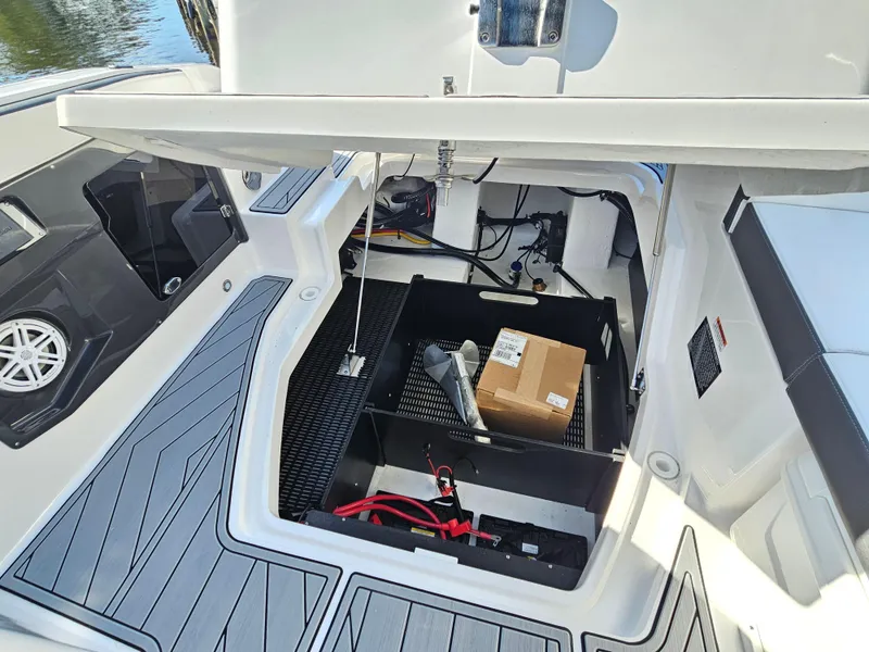 Slide: The Image of 2025 Monterey 255SS boat storage compartment with open hatch, showcasing interior equipment and accessories. - 36