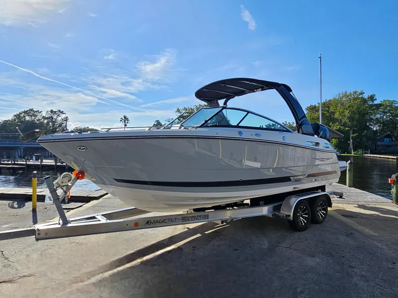 Slide: The Image of 2025 Monterey 255SS boat on trailer, dockside under clear blue sky. - 37