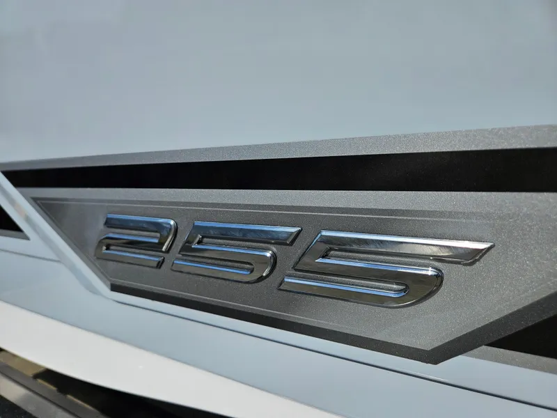 Slide: The Image of 2025 Monterey 255SS emblem, sleek metallic design on a modern boat exterior. - 38