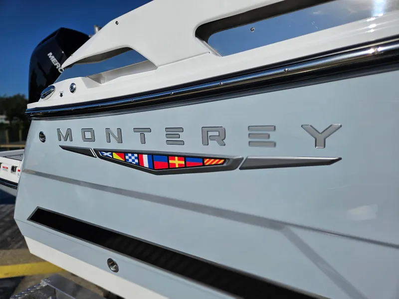 Slide: The Image of 2025 Monterey 255SS boat with logo and nautical flags on the side. - 39