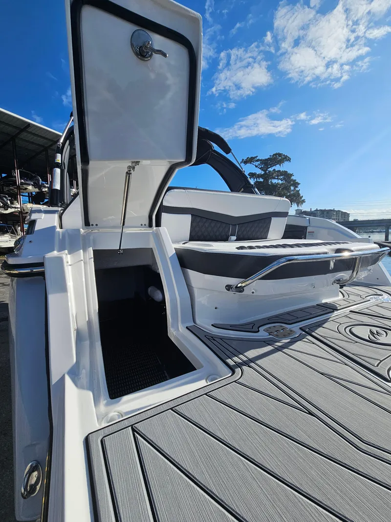 Slide: The Image of 2025 Monterey 255SS boat with open storage, sleek design, and sunny sky background. - 7