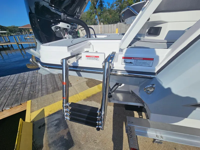Slide: The Image of 2025 Monterey 255SS boat with extended swim ladder at dockside. - 8